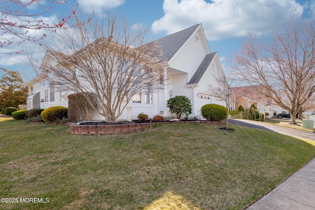 view of home's exterior featuring concrete driveway, a yard, and roof with shingles