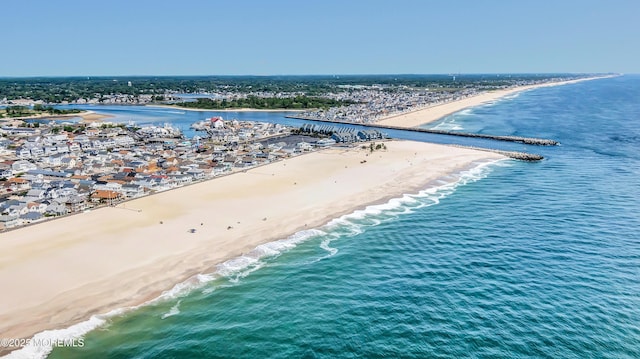 aerial view featuring a view of the beach and a water view