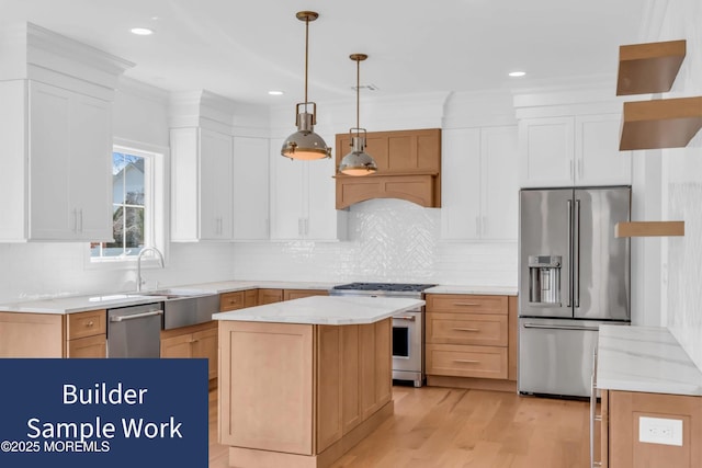 kitchen with high end appliances, a center island, hanging light fixtures, and white cabinets