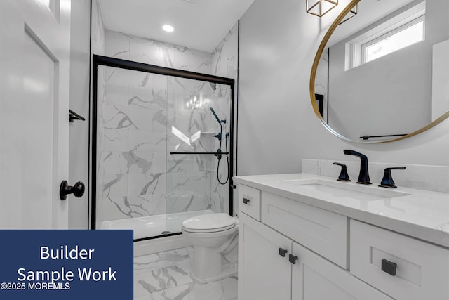 bathroom with vanity, toilet, and a shower with shower door