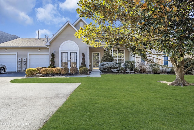 view of front of house featuring a garage and a front lawn