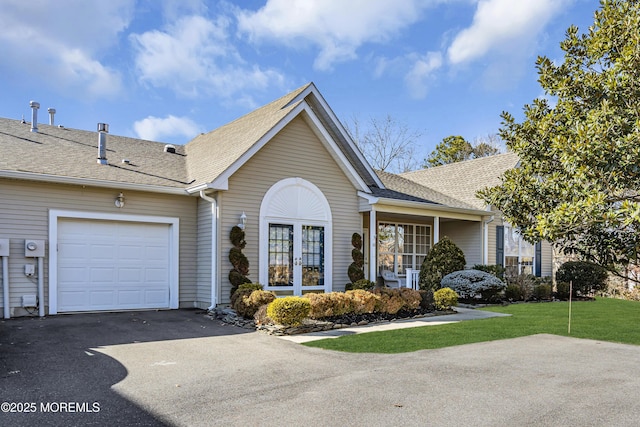 view of front of home with a garage and a front yard