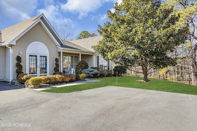 view of front of home featuring a front yard and french doors