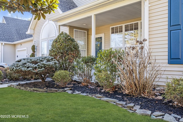 view of exterior entry with a lawn