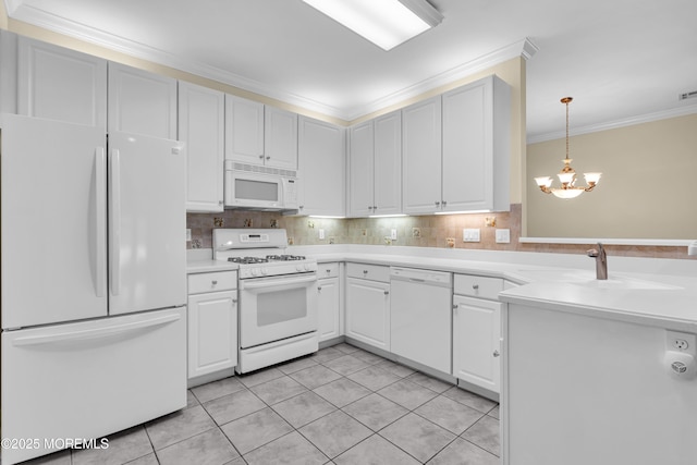 kitchen with sink, white cabinets, ornamental molding, a notable chandelier, and white appliances