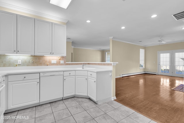 kitchen featuring a baseboard heating unit, dishwasher, sink, and white cabinets