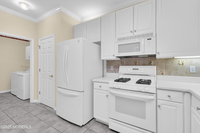 kitchen featuring washer and dryer, white cabinetry, backsplash, crown molding, and white appliances