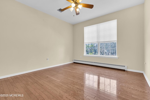 unfurnished room with ceiling fan, baseboard heating, and light hardwood / wood-style floors