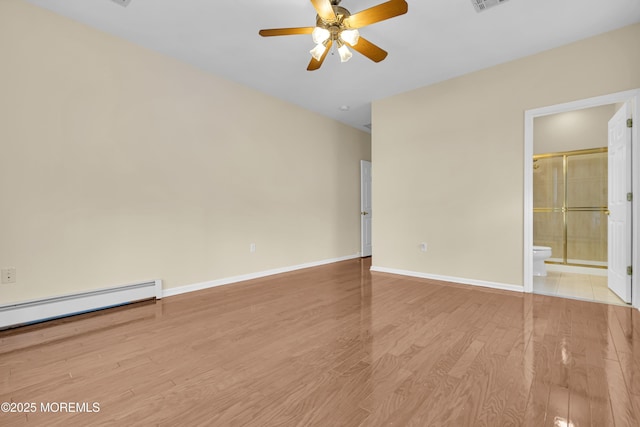 empty room with a baseboard radiator, ceiling fan, and light hardwood / wood-style flooring