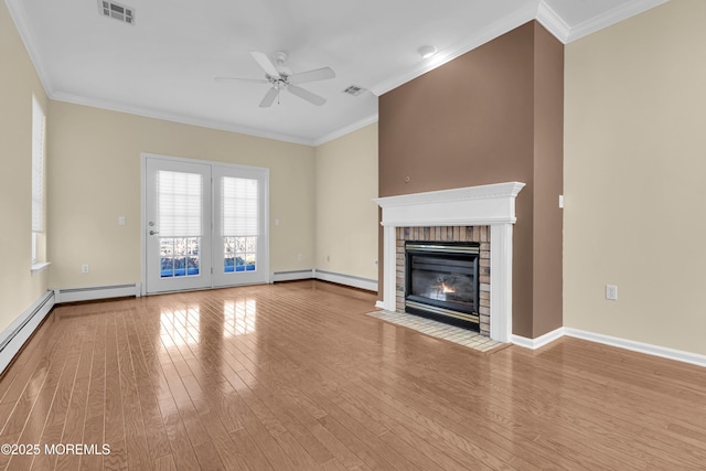 unfurnished living room with crown molding, a brick fireplace, and light wood-type flooring