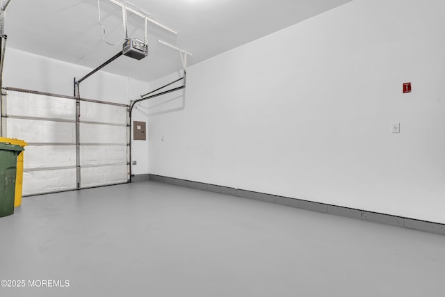 garage with a garage door opener and electric panel