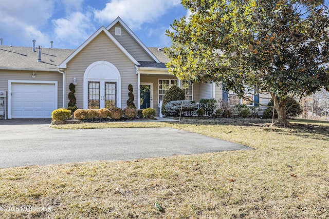 view of front facade with a garage and a front lawn