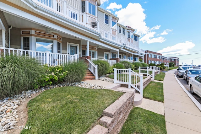 view of front of house with a front lawn and a porch