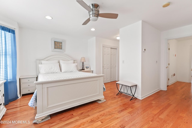 bedroom featuring ceiling fan, a closet, and light hardwood / wood-style flooring