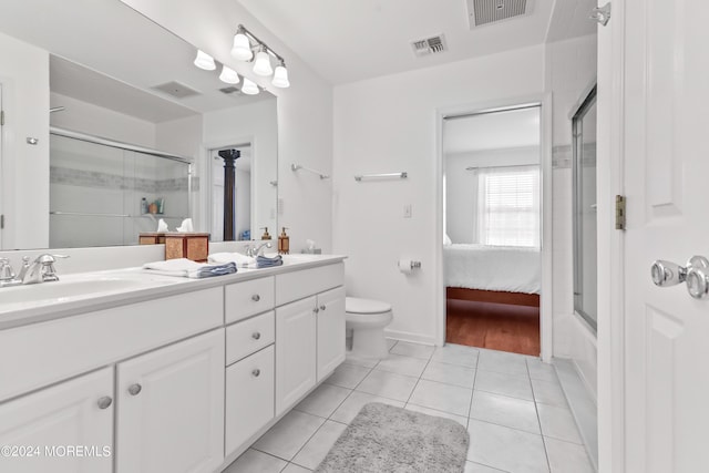 full bathroom featuring bath / shower combo with glass door, vanity, toilet, and tile patterned flooring