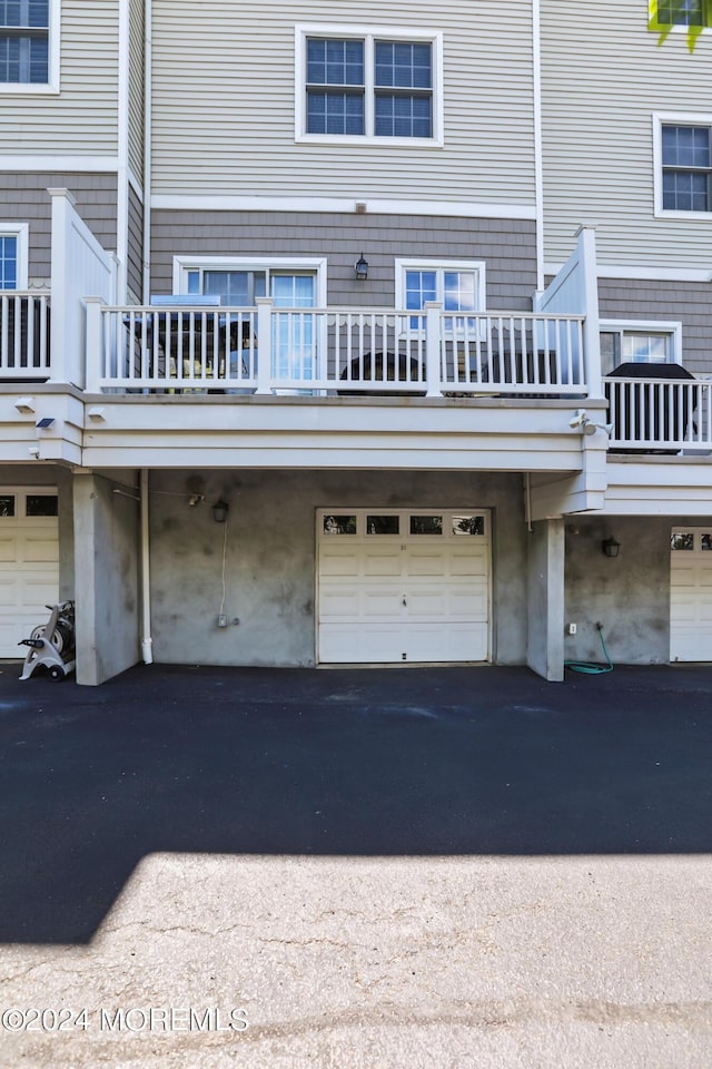 rear view of house featuring a garage