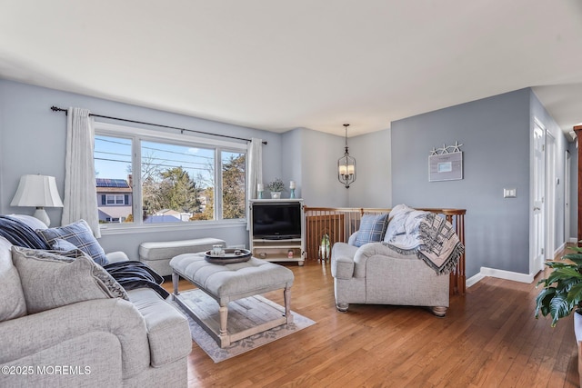 living room with hardwood / wood-style floors and a chandelier