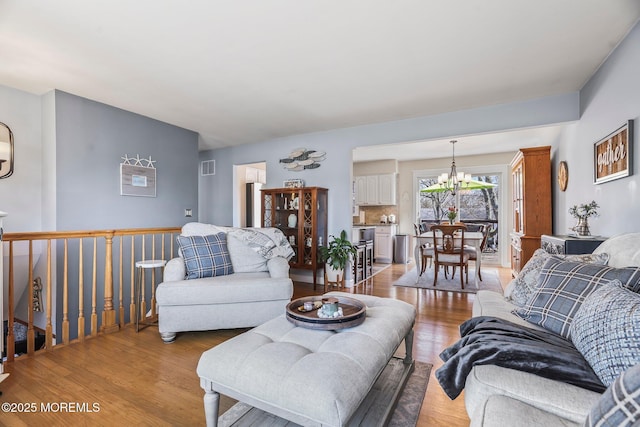 living room featuring a chandelier and hardwood / wood-style floors