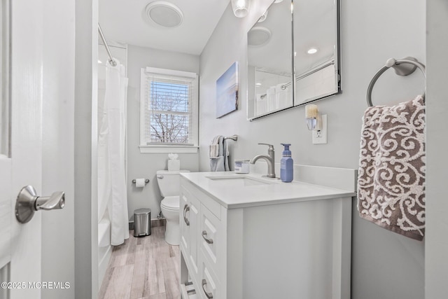 full bathroom featuring vanity, wood-type flooring, toilet, and shower / bath combo