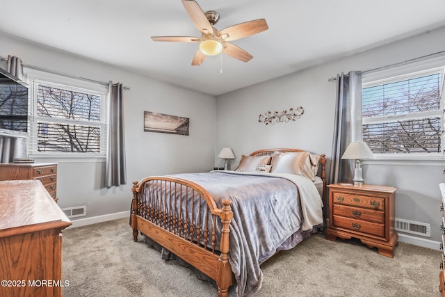 bedroom featuring light carpet, multiple windows, and ceiling fan