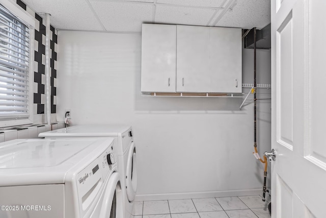 washroom featuring cabinets and separate washer and dryer