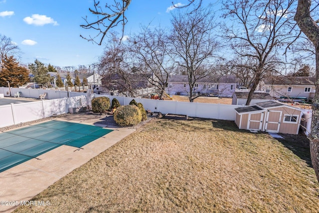 view of swimming pool with a storage shed, a yard, and a patio