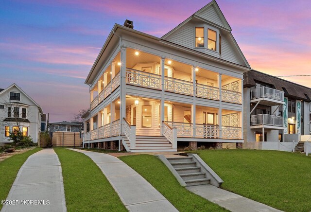 402 Fifth Ave, Asbury Park, NJ 07712 - view of front facade with a balcony, a chimney, a porch, and stairway