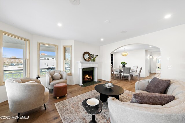 402 Fifth Ave, Asbury Park, NJ 07712 - living area with arched walkways, wood finished floors, recessed lighting, and a fireplace with flush hearth
