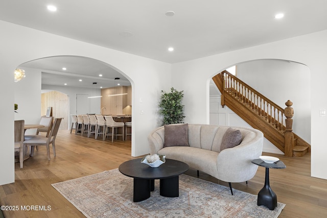 402 Fifth Ave, Asbury Park, NJ 07712 - living area with arched walkways, wood finished floors, recessed lighting, and stairs