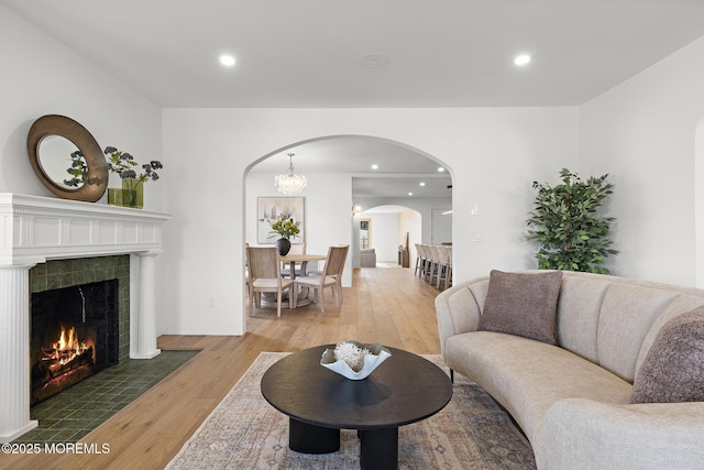 402 Fifth Ave, Asbury Park, NJ 07712 - living room featuring wood finished floors, arched walkways, a tiled fireplace, and recessed lighting