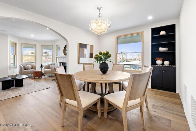 402 Fifth Ave, Asbury Park, NJ 07712 - dining area with arched walkways, a fireplace, plenty of natural light, light wood-type flooring, and recessed lighting
