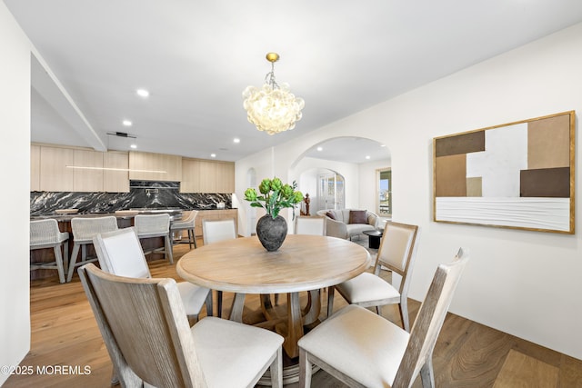 402 Fifth Ave, Asbury Park, NJ 07712 - dining area with arched walkways, recessed lighting, light wood-type flooring, and a chandelier