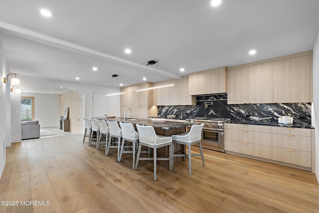 402 Fifth Ave, Asbury Park, NJ 07712 - kitchen featuring modern cabinets, high end stove, light brown cabinets, and recessed lighting