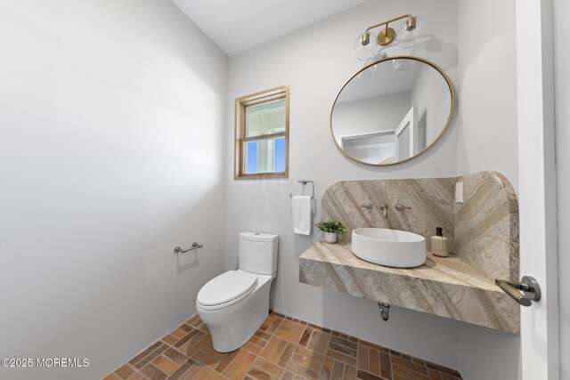 402 Fifth Ave, Asbury Park, NJ 07712 - half bath with brick patterned flooring, a sink, and toilet