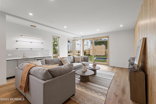 402 Fifth Ave, Asbury Park, NJ 07712 - living area featuring light wood-style floors, bar with sink, and recessed lighting