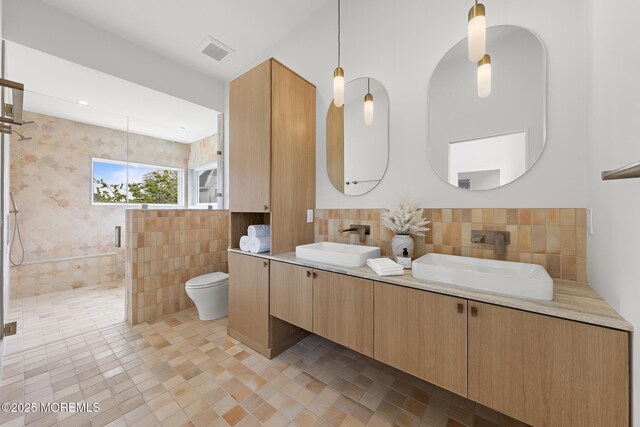 402 Fifth Ave, Asbury Park, NJ 07712 - bathroom featuring tile walls, a shower stall, tile patterned floors, double vanity, and toilet