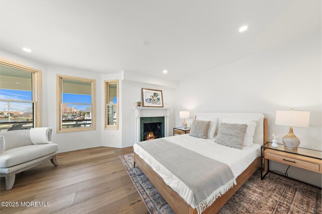 402 Fifth Ave, Asbury Park, NJ 07712 - bedroom with wood finished floors, a lit fireplace, and recessed lighting