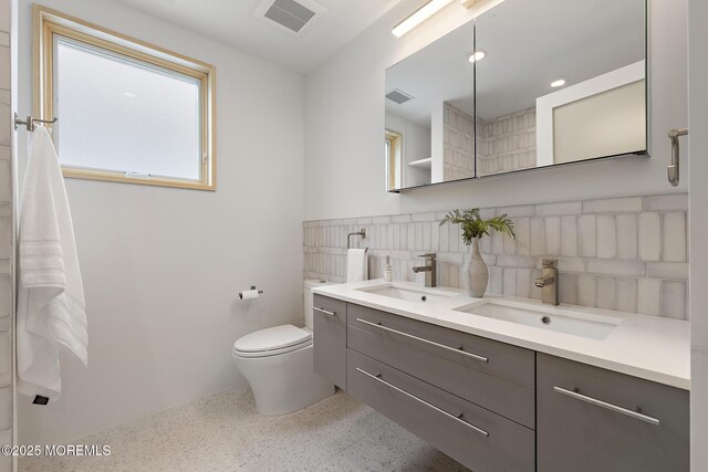 402 Fifth Ave, Asbury Park, NJ 07712 - bathroom featuring speckle patterned floor, toilet, double vanity, and tile walls