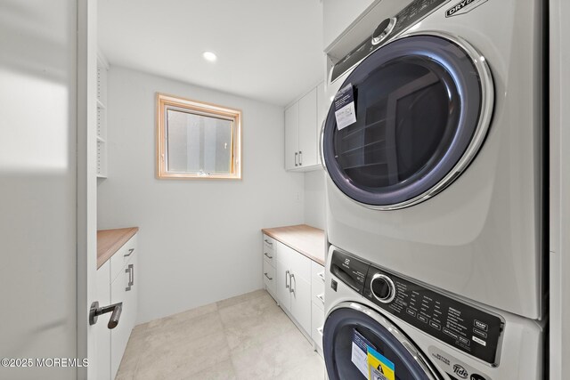 402 Fifth Ave, Asbury Park, NJ 07712 - laundry room featuring stacked washing machine and dryer and cabinet space
