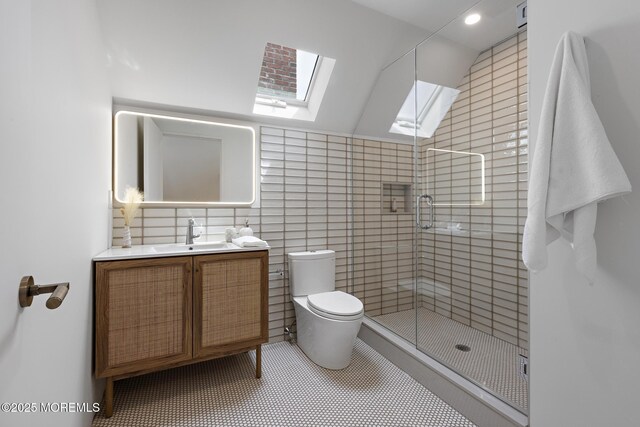 402 Fifth Ave, Asbury Park, NJ 07712 - full bathroom featuring a skylight, a stall shower, toilet, vanity, and recessed lighting