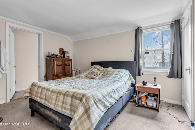 carpeted bedroom featuring ornamental molding, vaulted ceiling, and baseboards