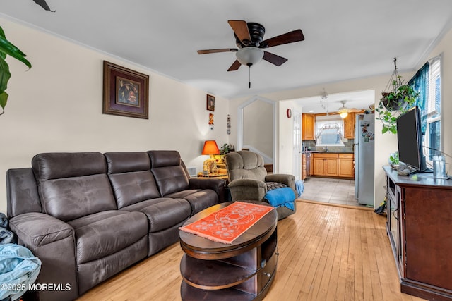 living area featuring ceiling fan and light wood-style flooring