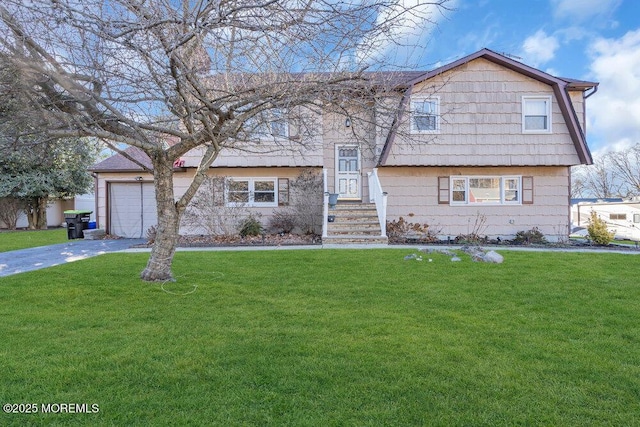 view of front of house featuring a garage and a front yard