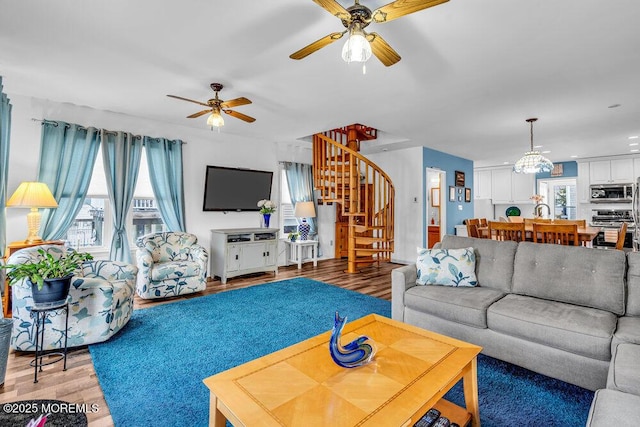 living room with wood-type flooring and ceiling fan