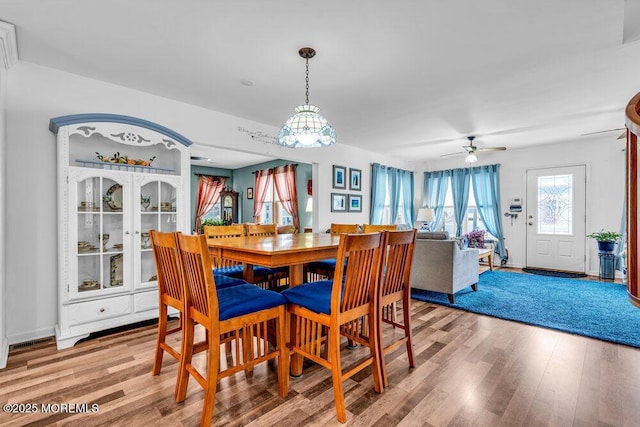 dining room with wood-type flooring and ceiling fan