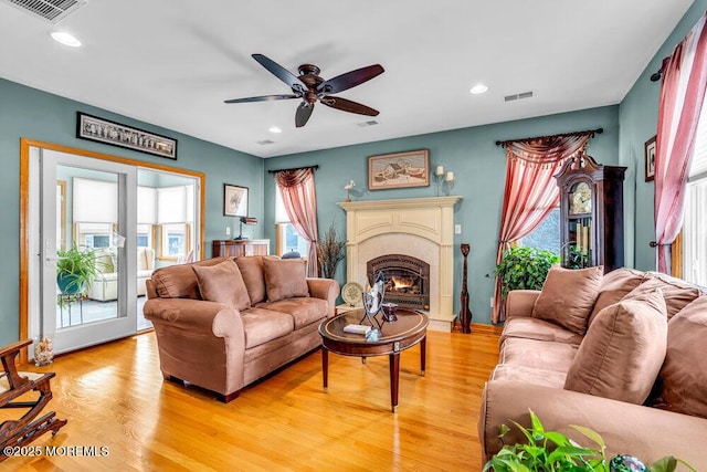 living room with ceiling fan and light hardwood / wood-style floors