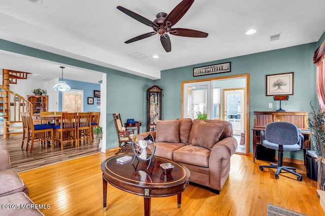 living room featuring ceiling fan and light wood-type flooring