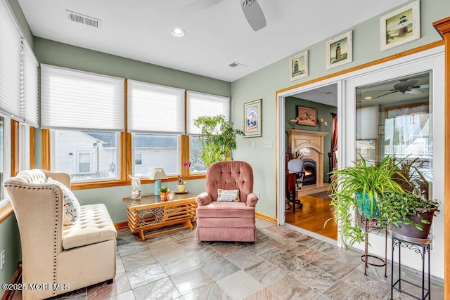 living area with ceiling fan