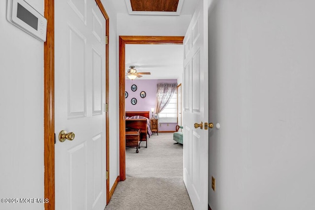 corridor featuring light colored carpet