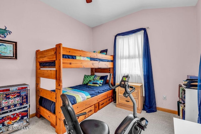 bedroom with lofted ceiling and light carpet